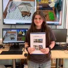 Nikola holding up her CREST project