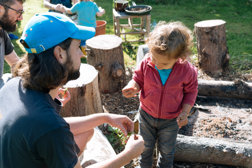 Stock Photo of Young Child and Male Adults Outdoor Play