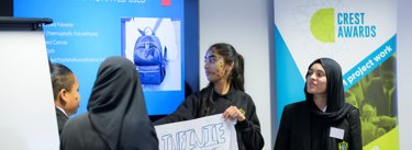 BSA Mewburn Ellis Discovery Day Image Widget Two Students Presenting Against A CREST Pull Up Banner
